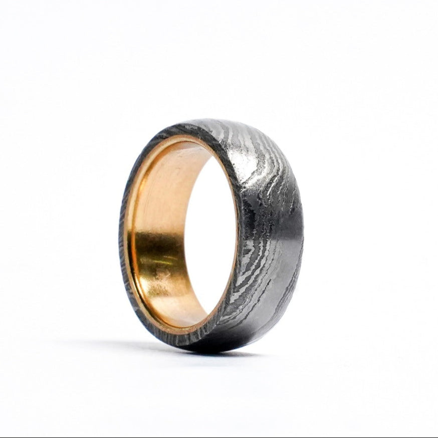 Brass Damascus ring against white background
