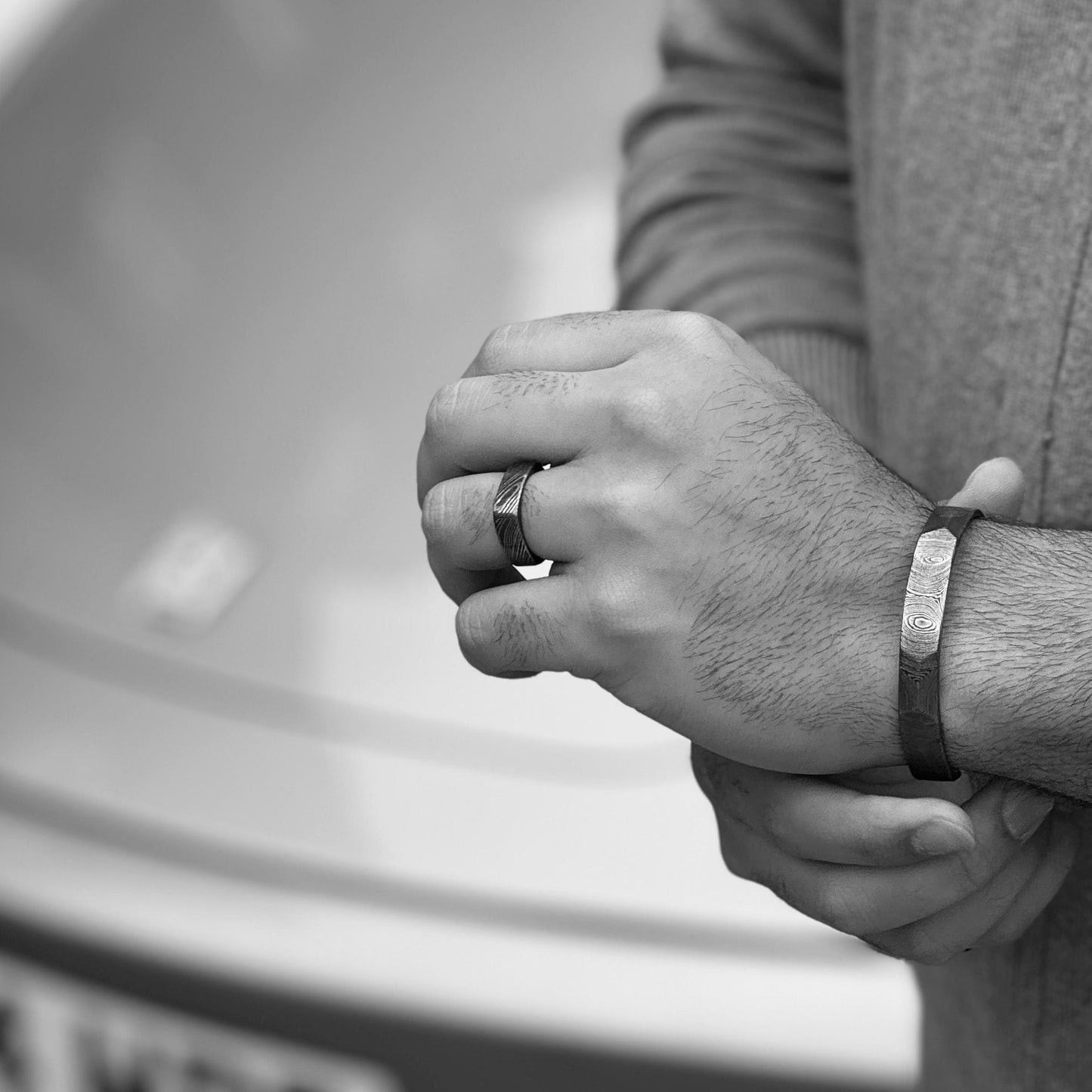 man wearing Damascus steel antler cuff black and white porche background