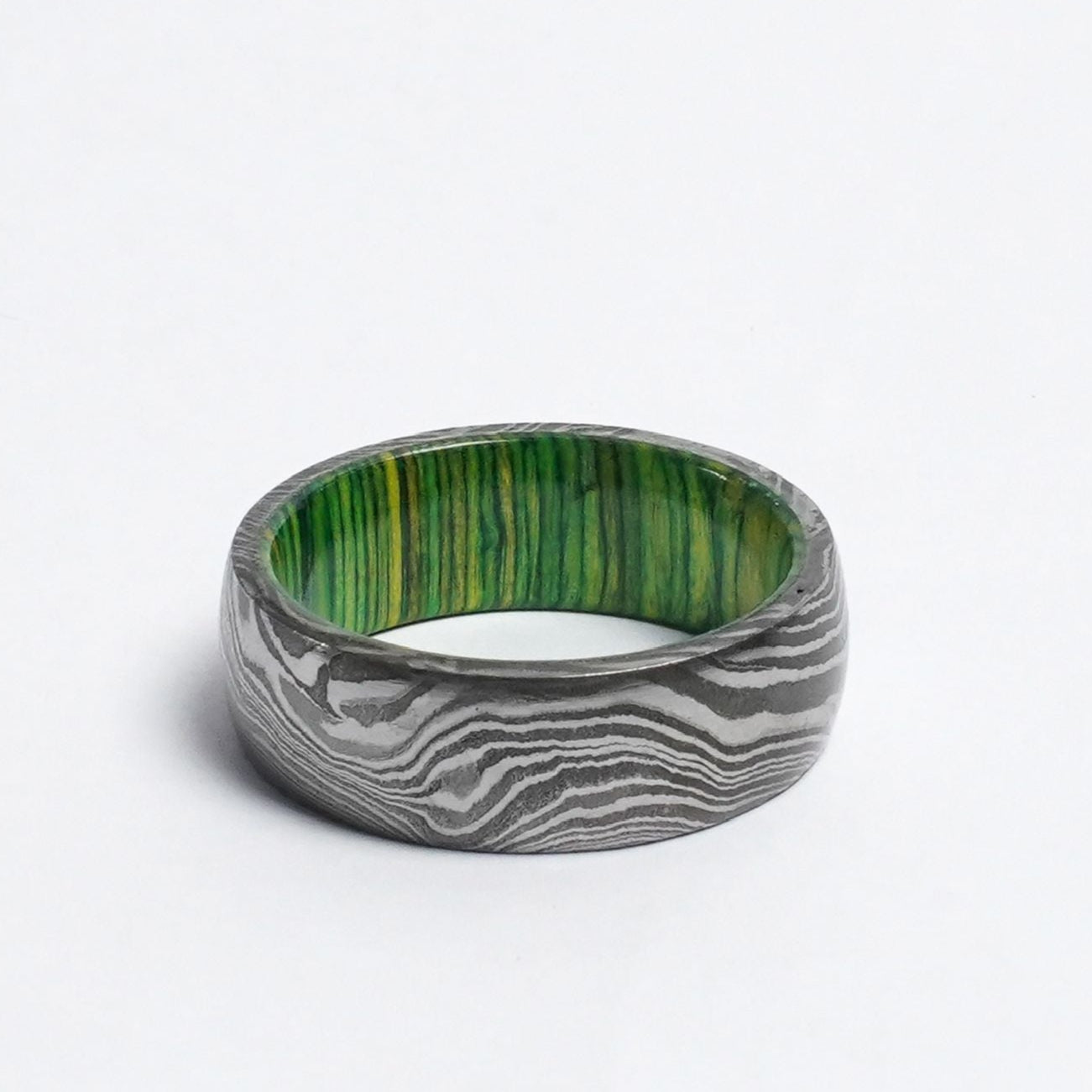 Damascus steel green wood ring close up[
