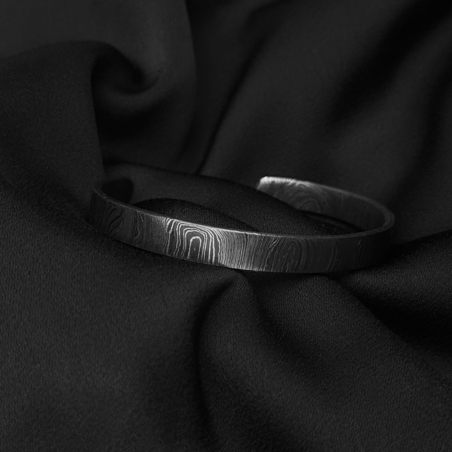 Damascus steel cuff on black silk