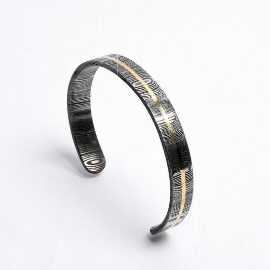 Damascus and brass antler cuff against white background