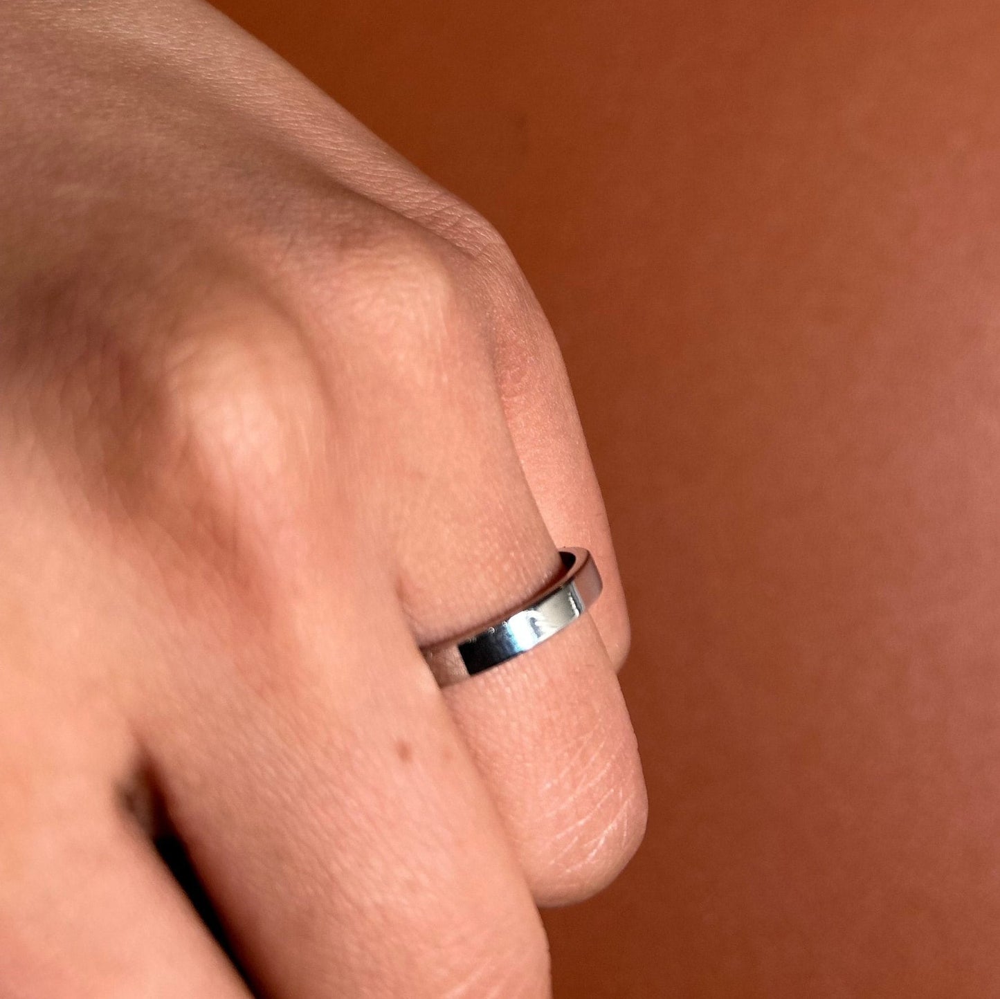 Minimalist stainless steel band on hand